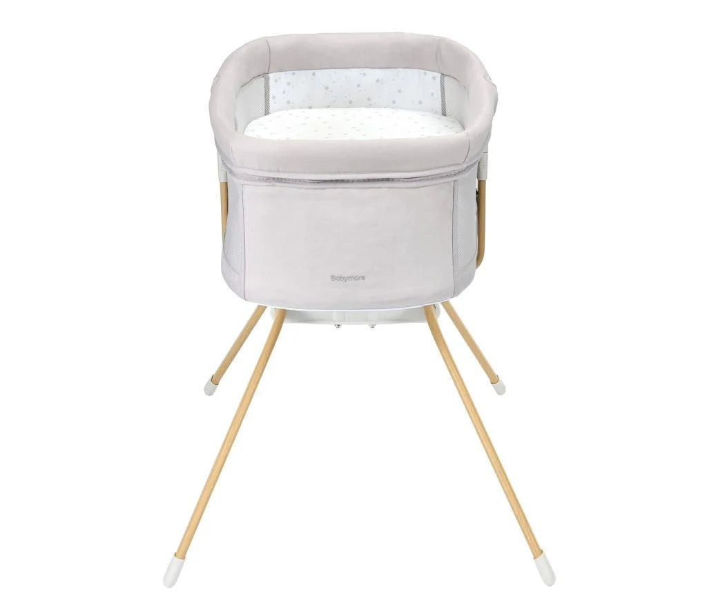 Baby bassinet with wooden legs on a white background