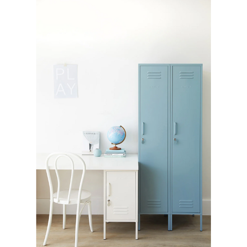 Light blue locker next to a white desk with a chair in a room.