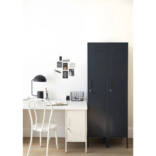 Navy blue locker next to a white desk with a chair in a room.