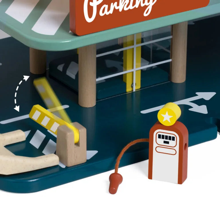 Toy parking garage set with a gas pump and arrows indicating directions.