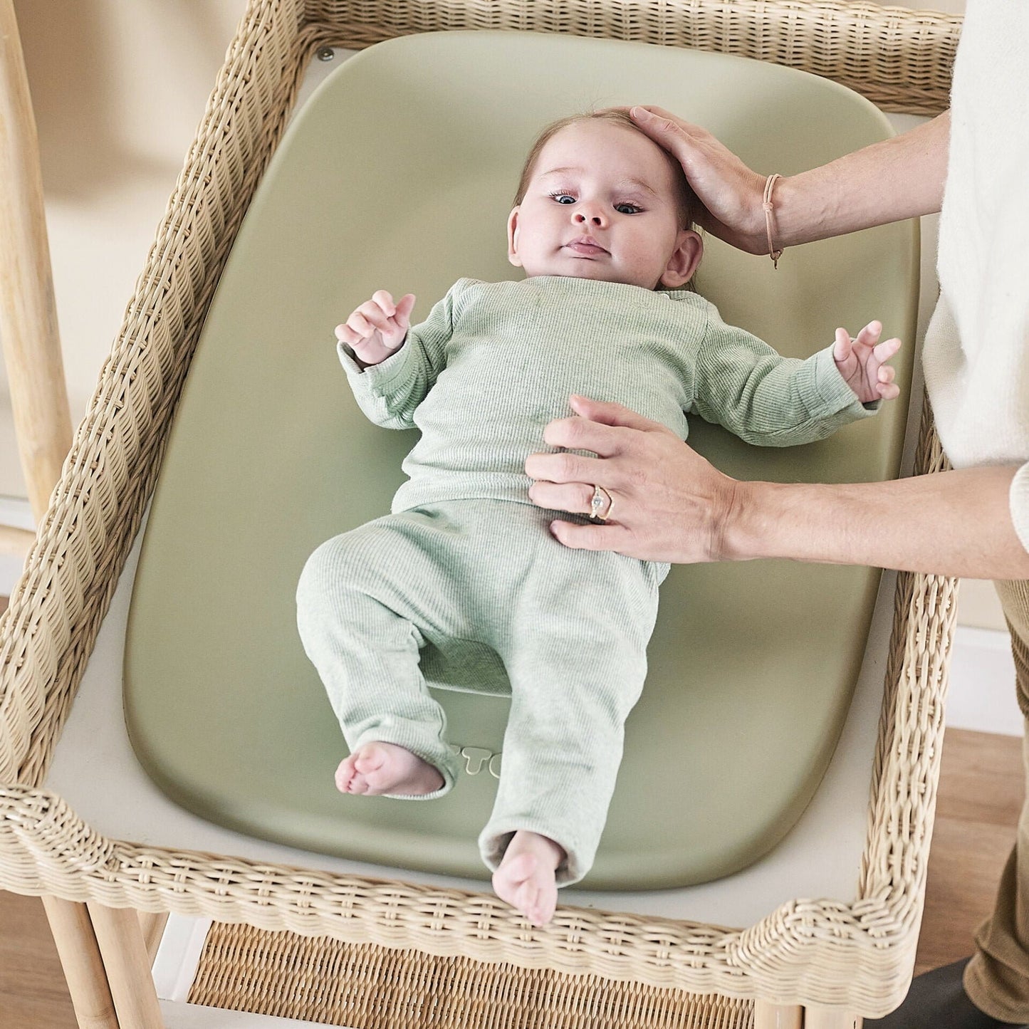 Baby on a green changing pad