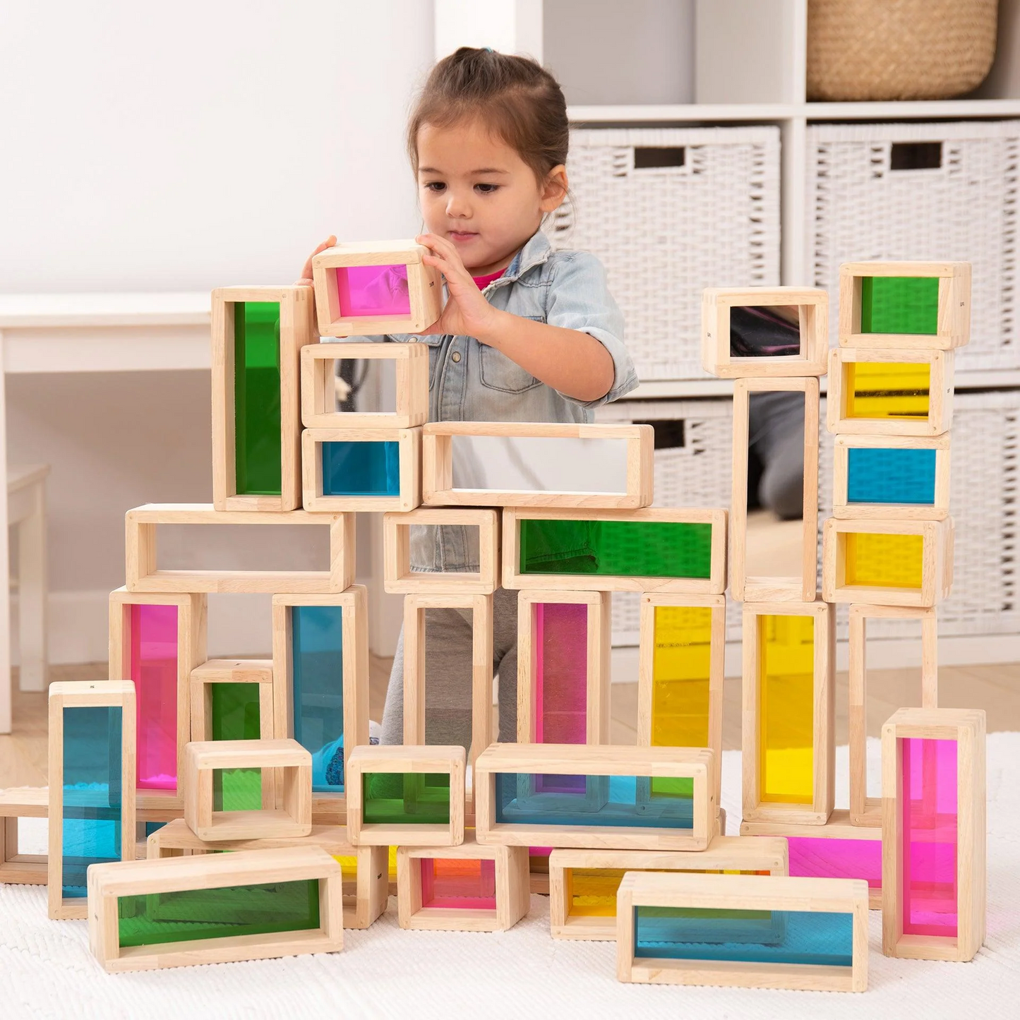 Child playing with colourful wooden blocks in a bright room