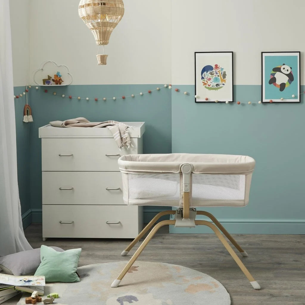 Nursery room with a crib, dresser, and decorative elements.
