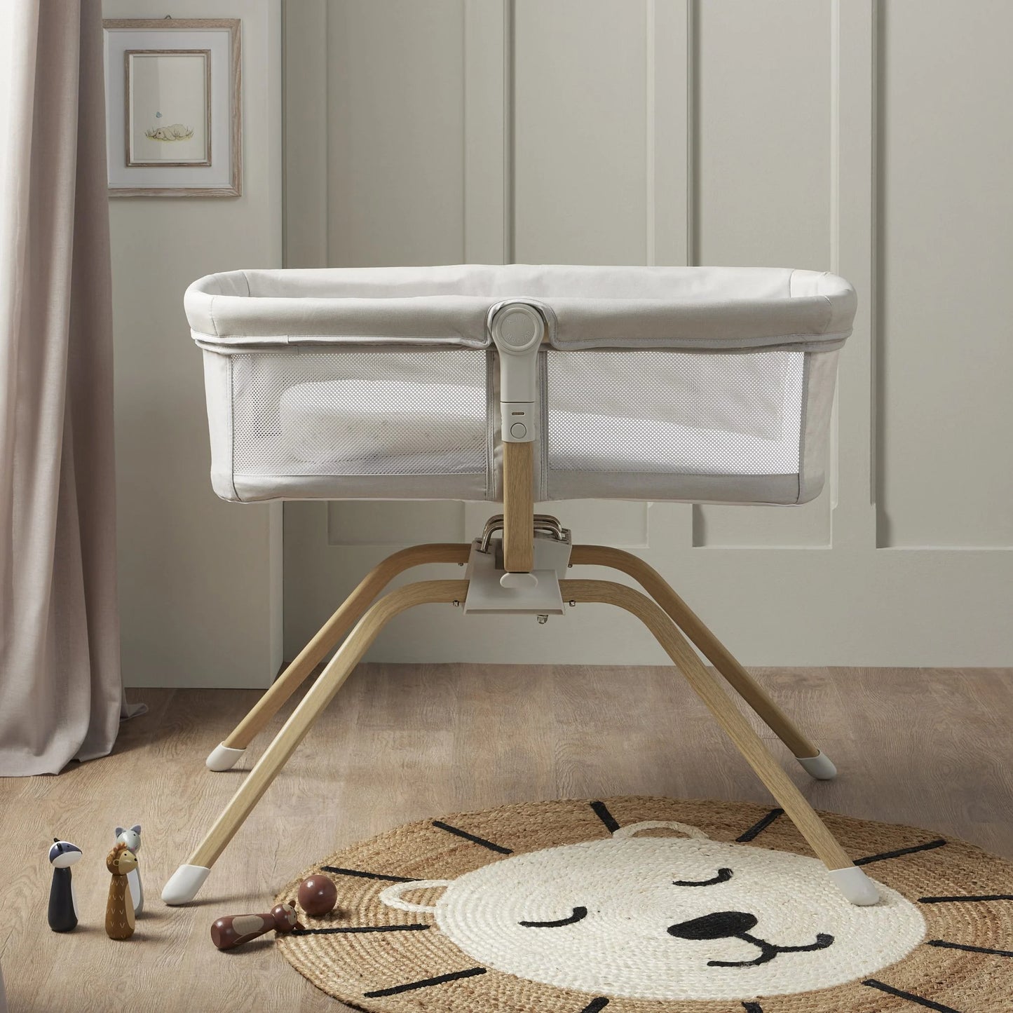 Baby crib with wooden base in a room setting