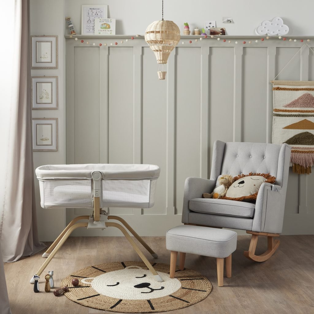 Nursery room with a crib, chair, and decorative elements.