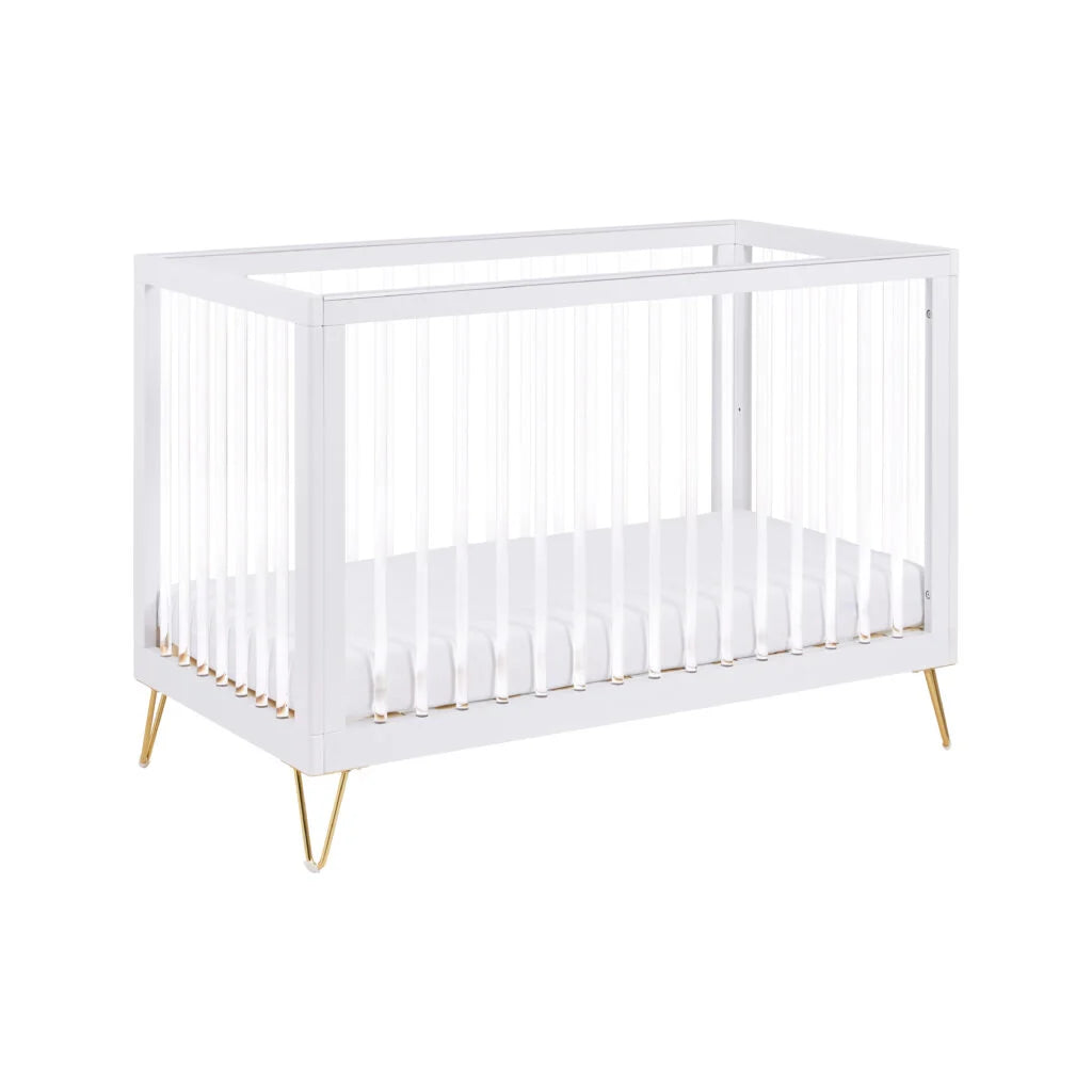 White crib with gold legs on a white background