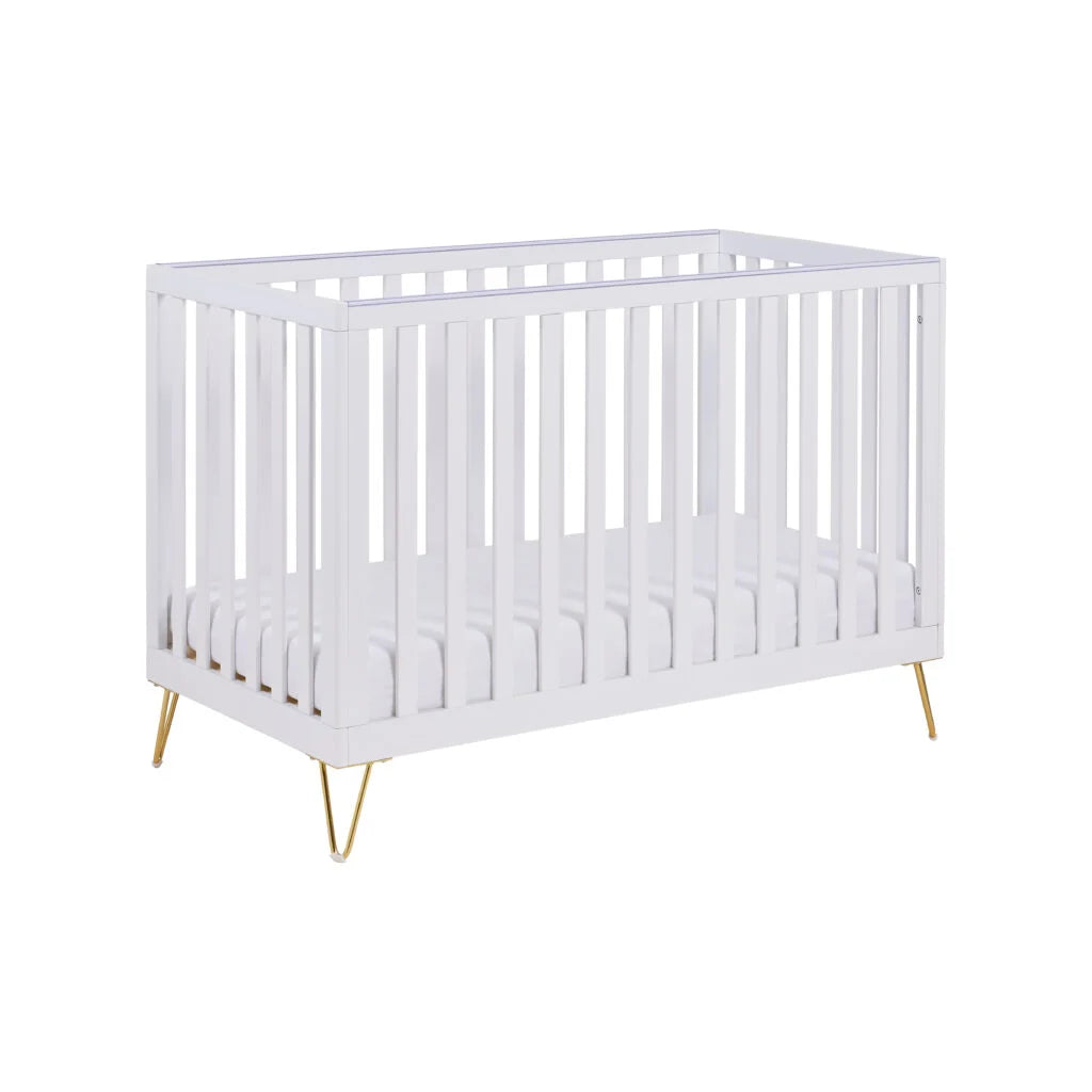 White crib with gold legs on a white background