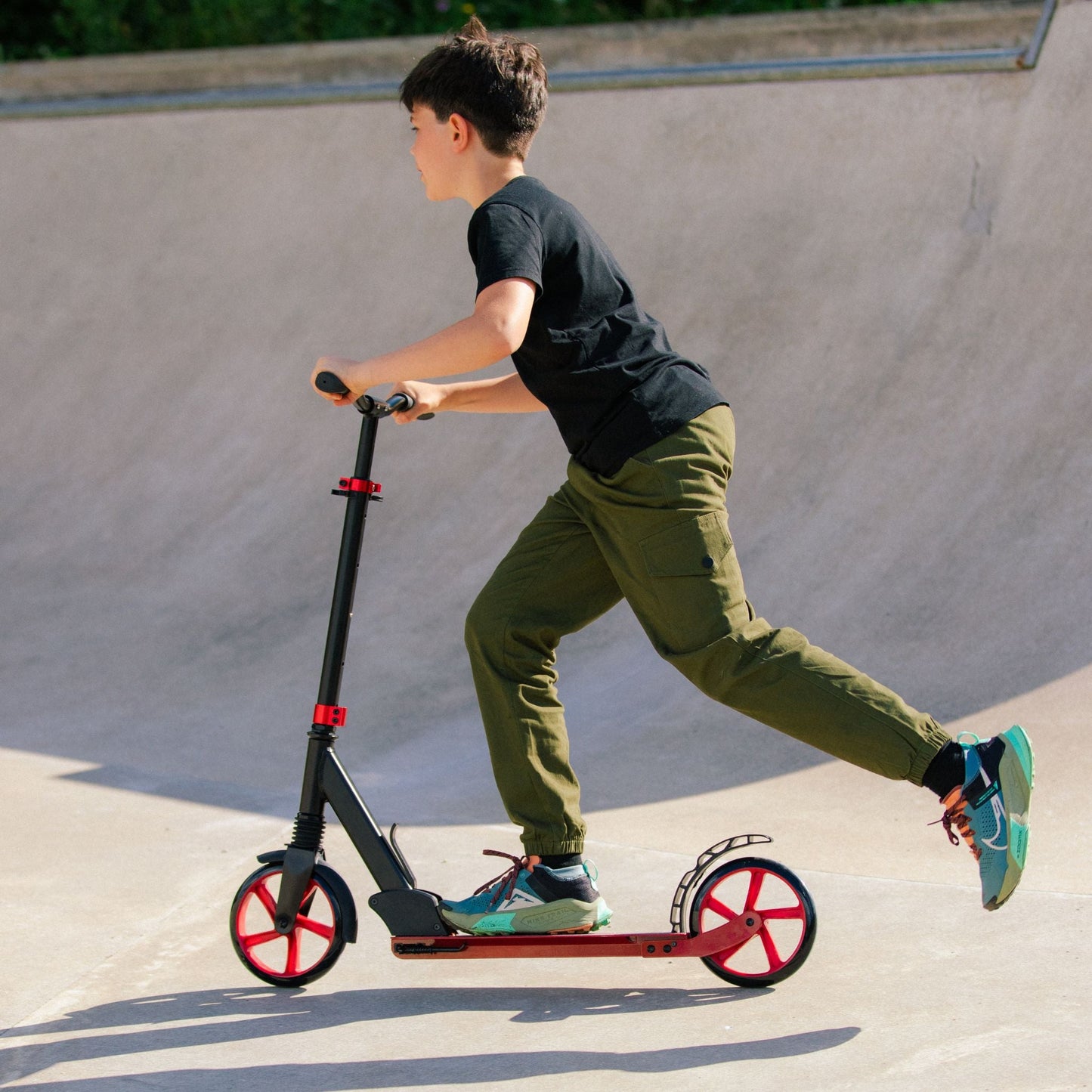 Person riding a scooter at a skate park