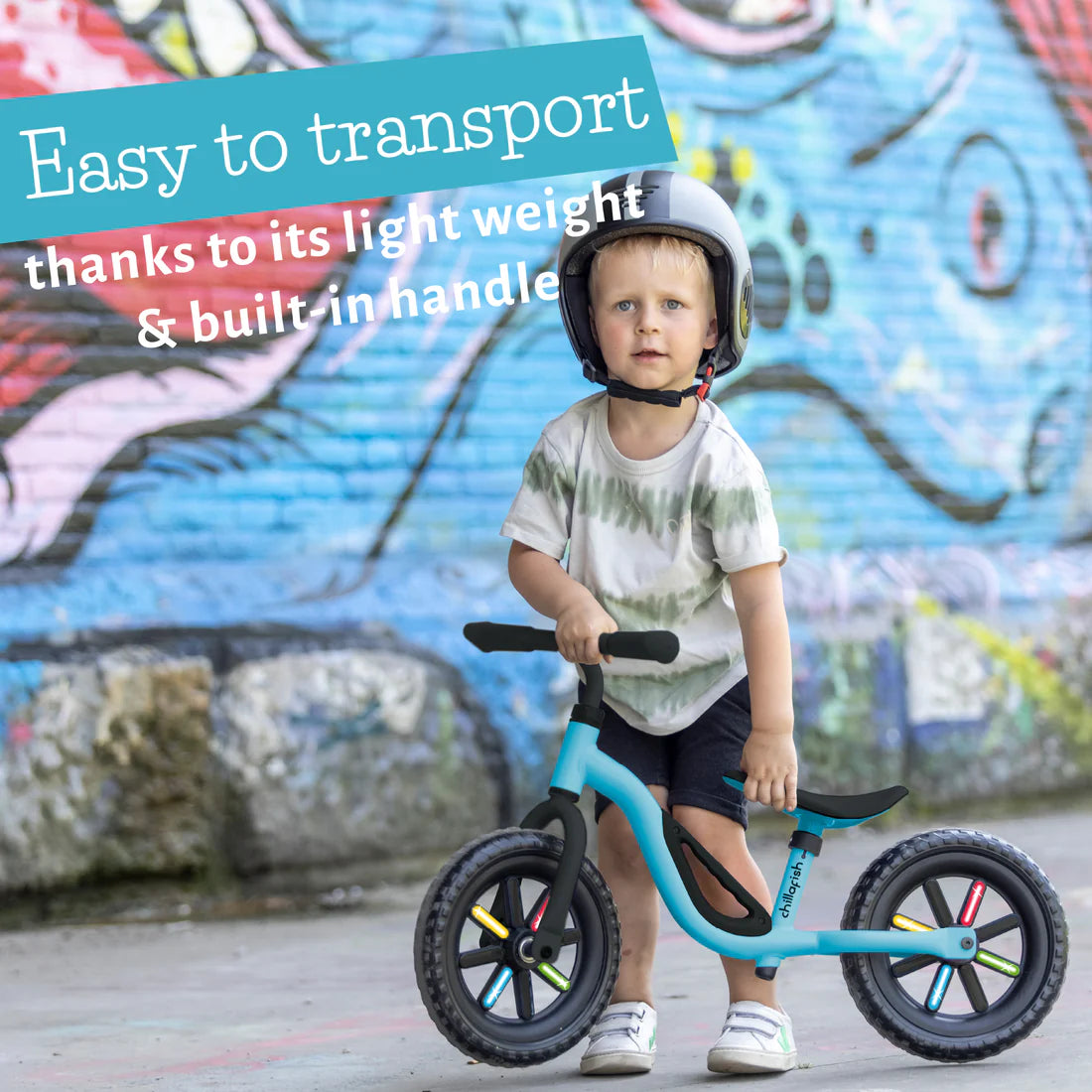 Child with a balance bike against a graffiti wall, with text about the bike's ease of transport.