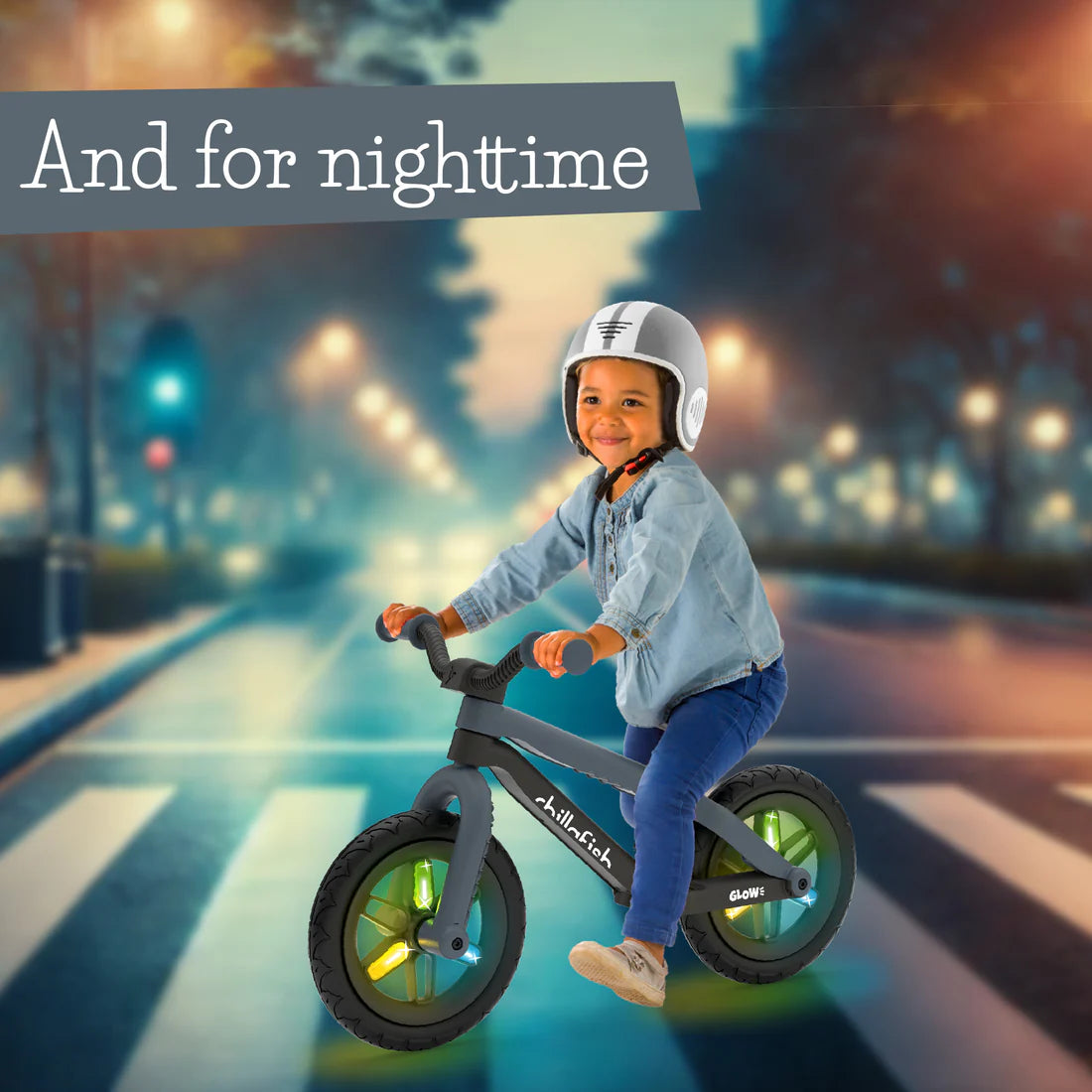 Child riding a balance bike on a city street at night with 'And for nighttime' text.
