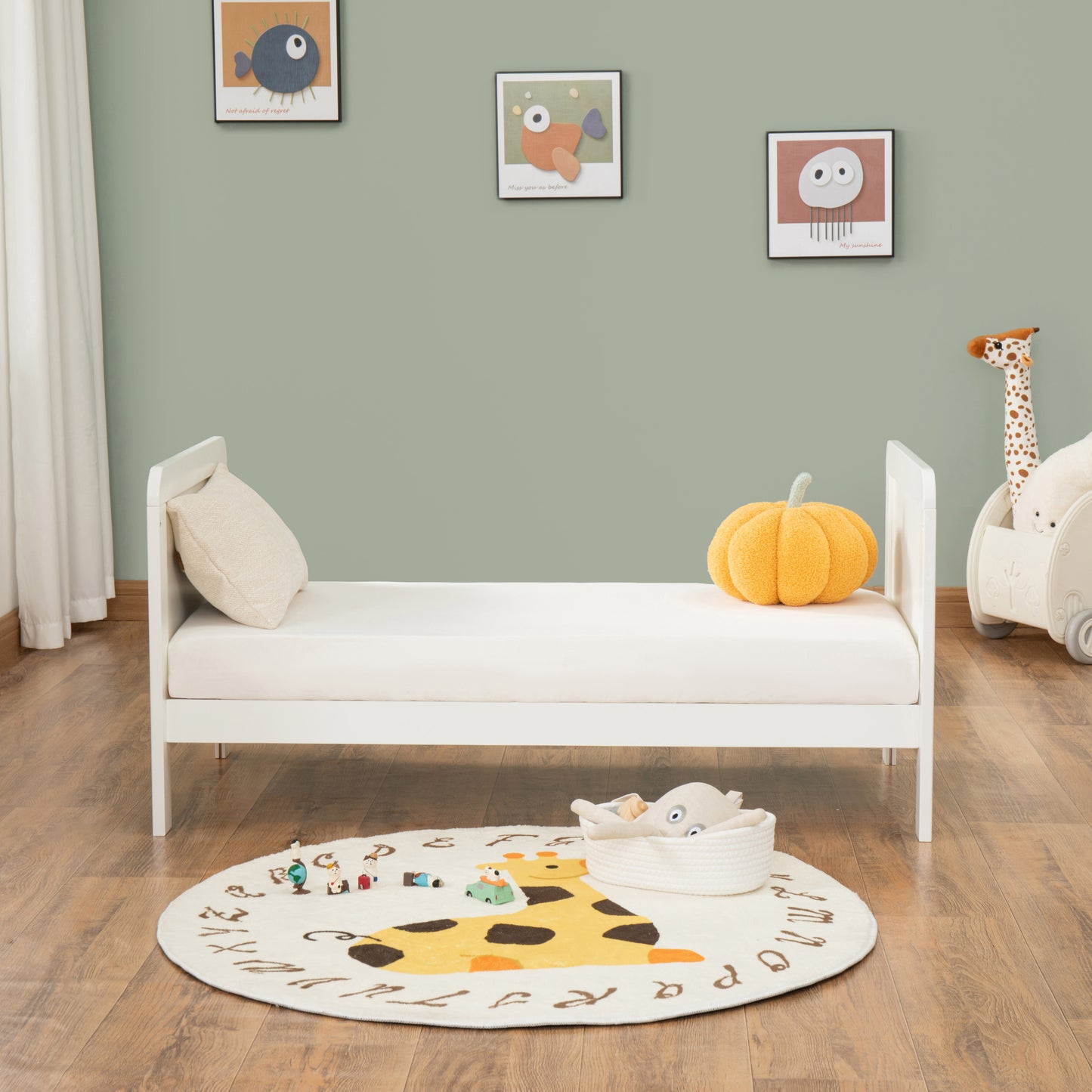 Children's room with a white bed, colourful rug, and toys on a wooden floor.