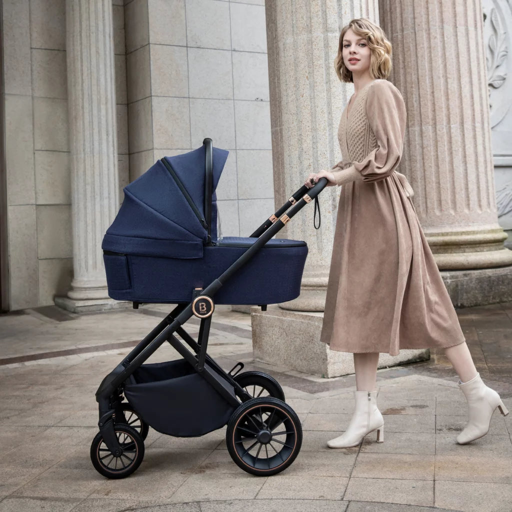 Woman pushing a navy blue stroller in an urban setting with classical architecture.