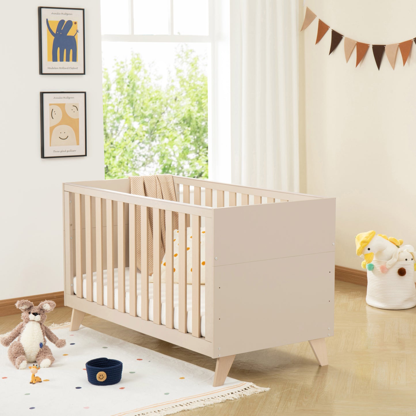 Wooden cot in a bright nursery with toys and decor
