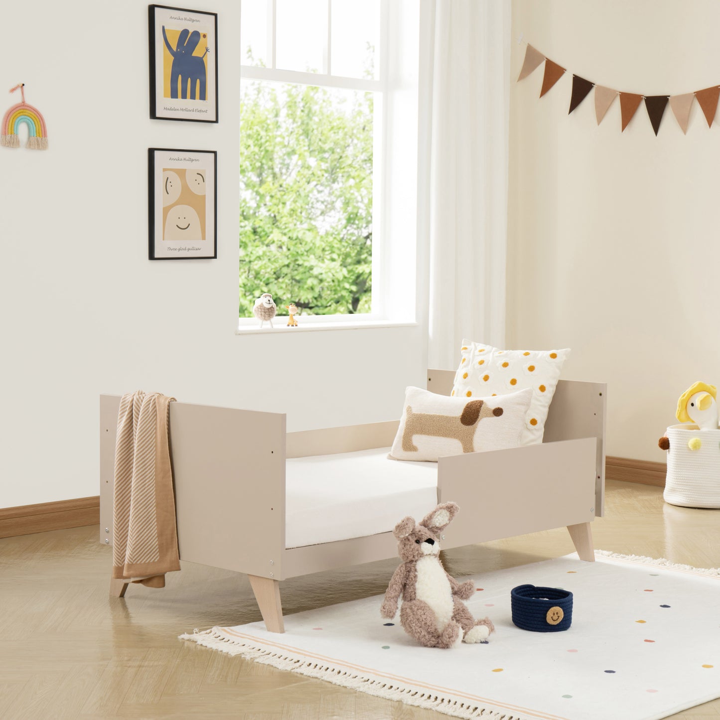 Children's room with a toddler bed, toys, and decorative elements.