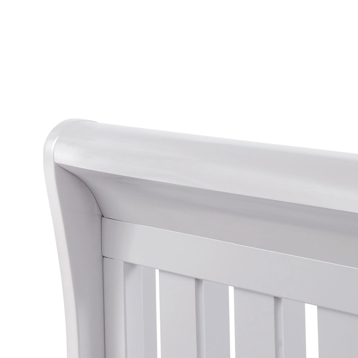 Close-up of a white crib with a plain background