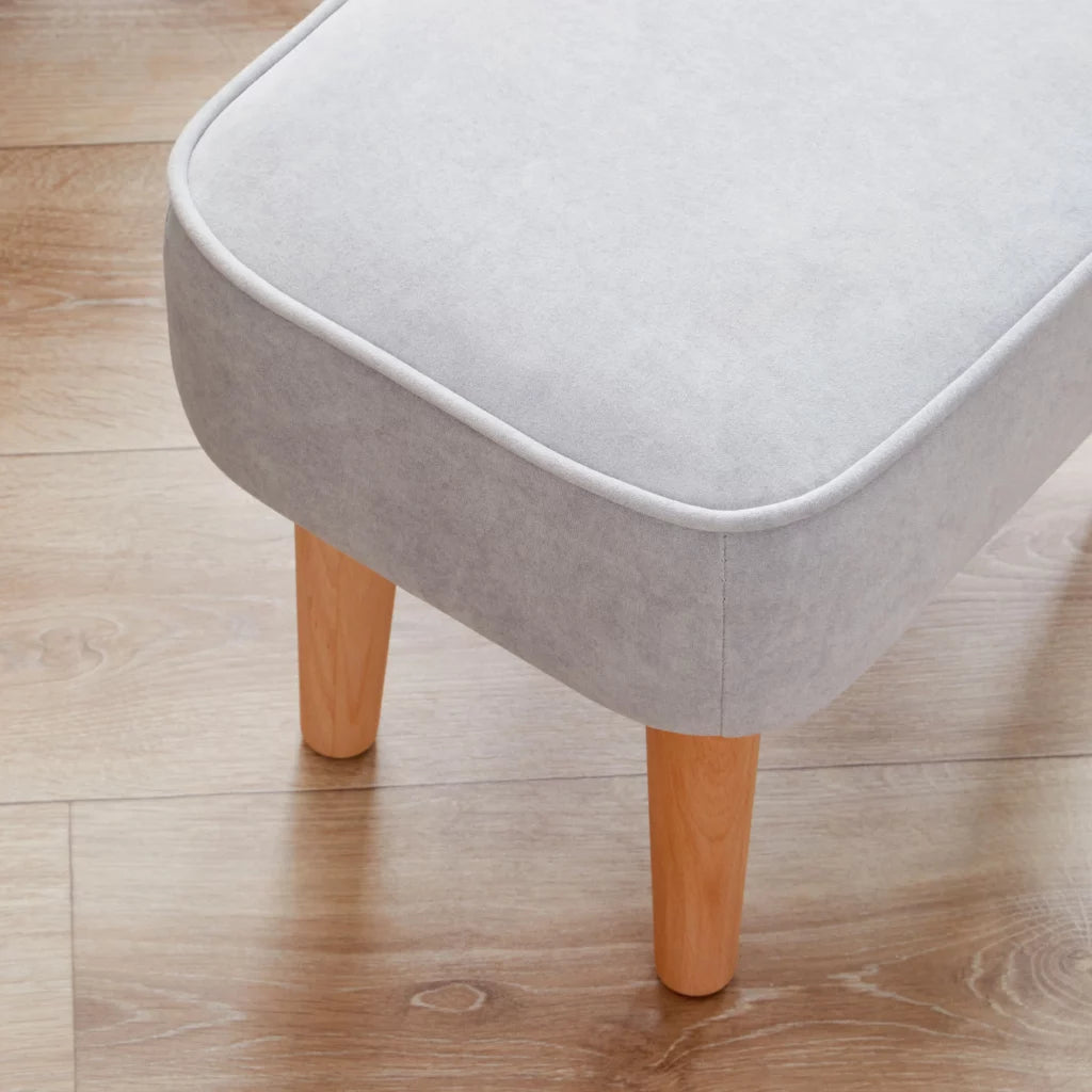 Gray stool with wooden legs on a wooden floor