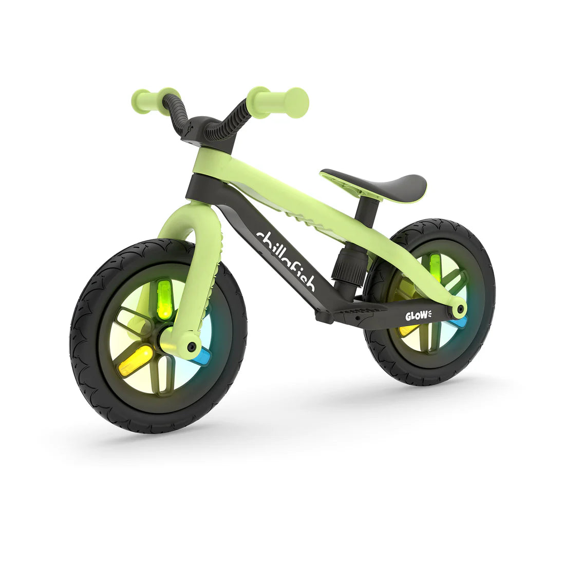 Children's balance bike with green frame and black wheels on a white background