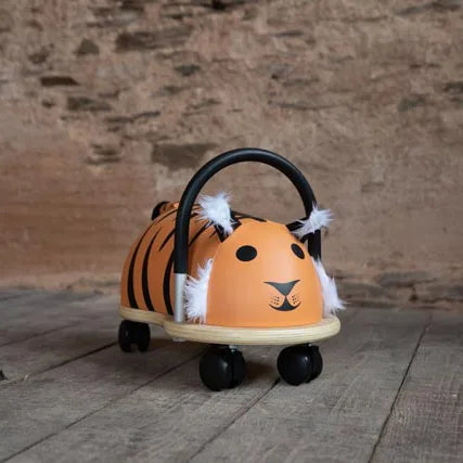 Toy car shaped like a tiger with black stripes on a wooden floor.