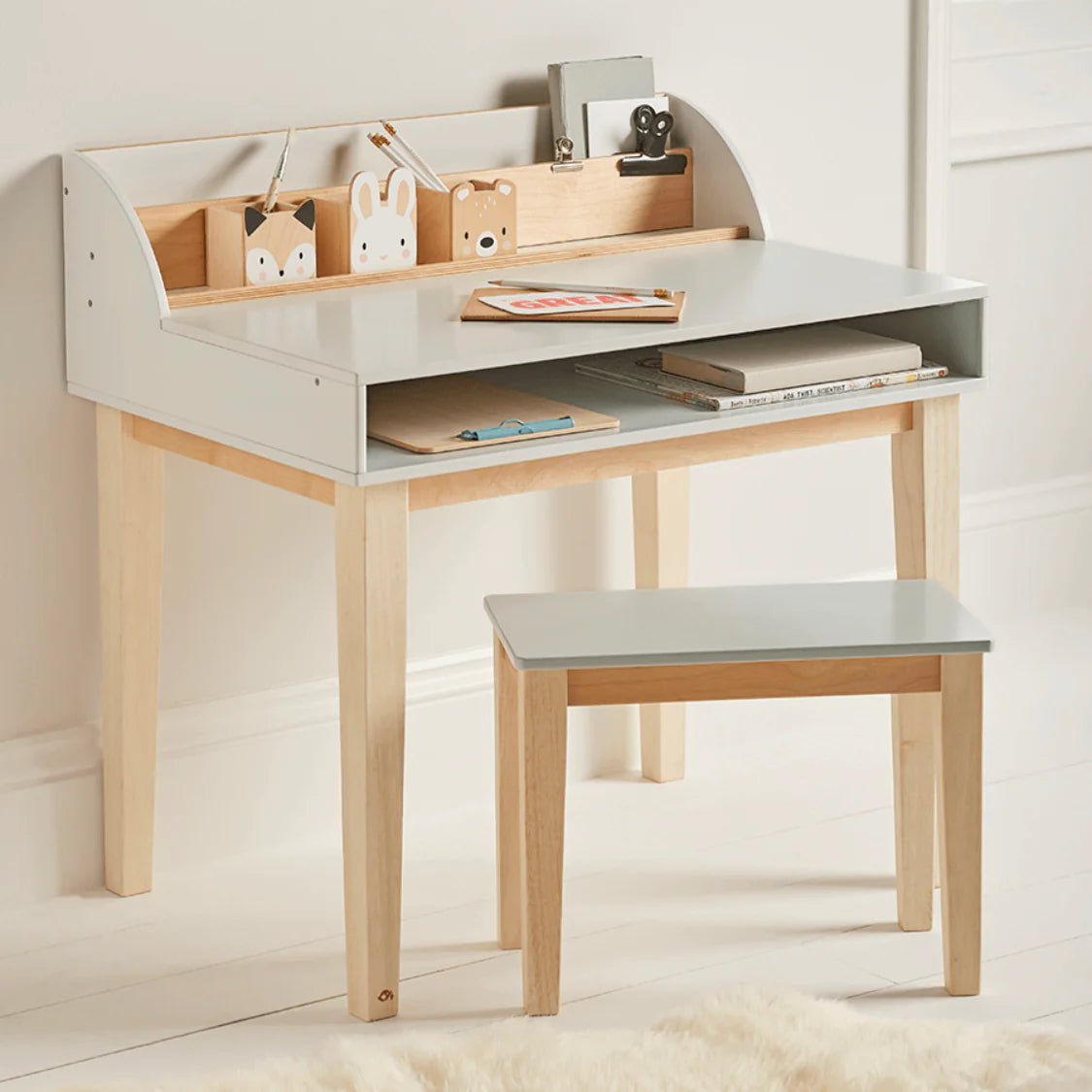 Children's desk with shelves and a chair in a room setting
