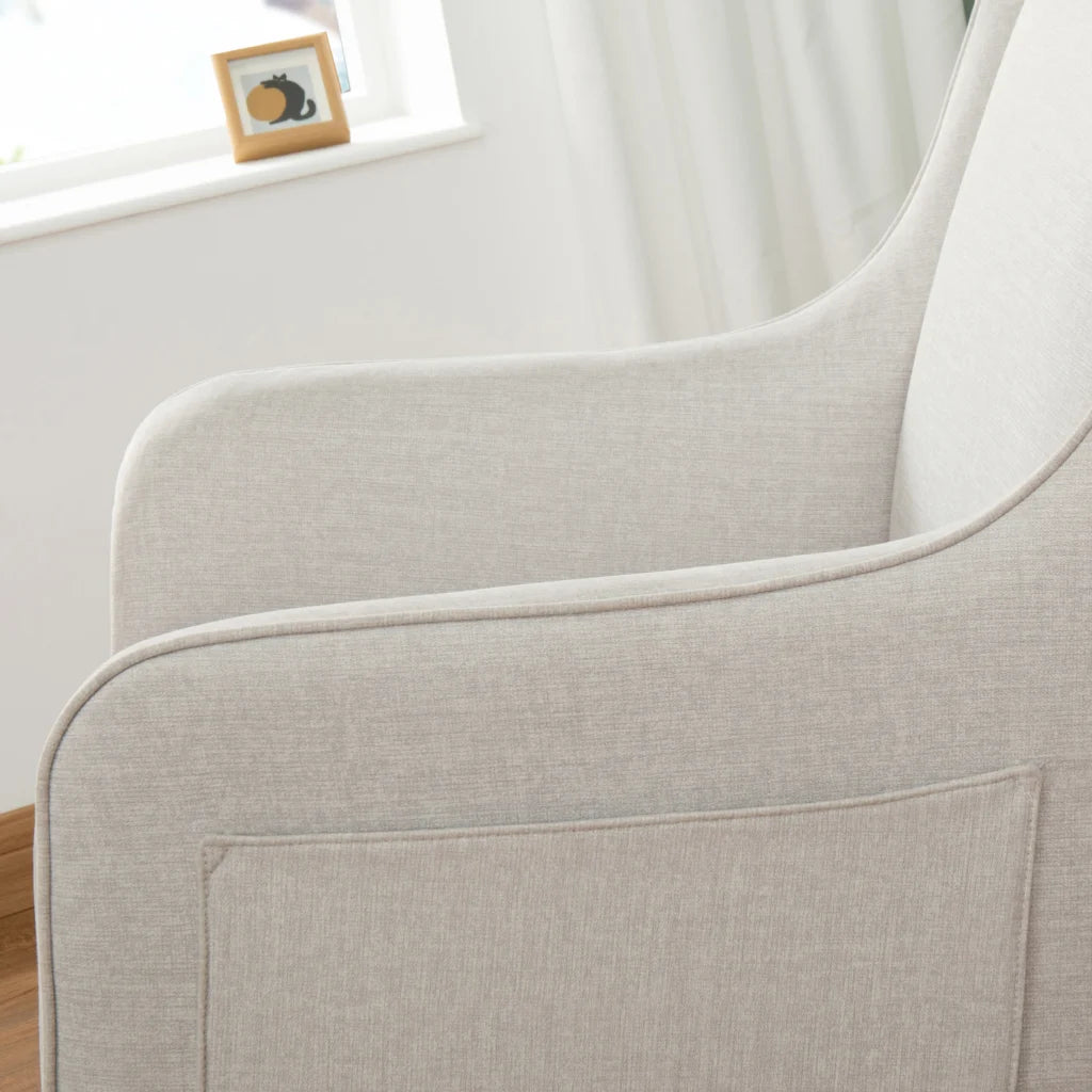 Close-up of a light gray upholstered chair with a blurred background