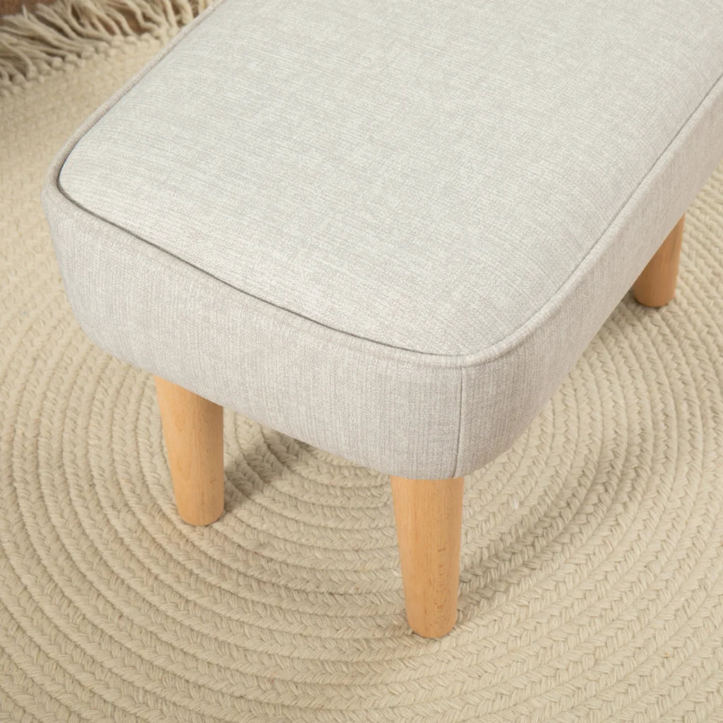 Light gray upholstered stool with wooden legs on a beige textured rug