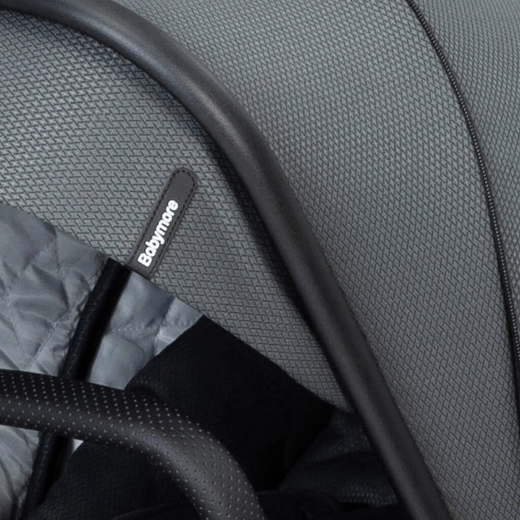 Close-up of a gray stroller seat with a visible brand label.