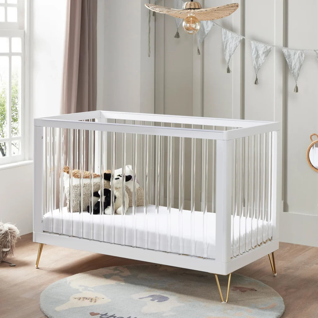 White crib with toys in a nursery setting