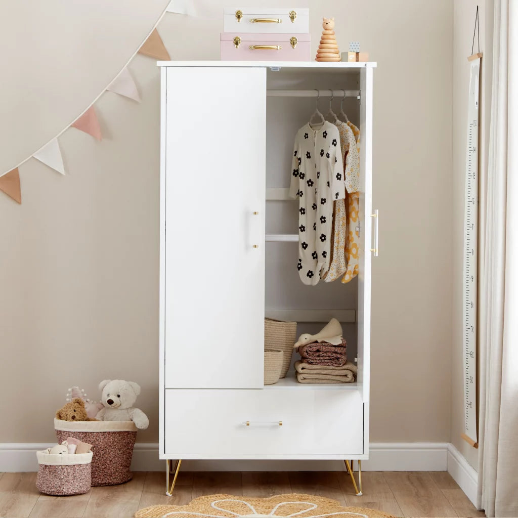 White wardrobe with clothes and toys in a child's room
