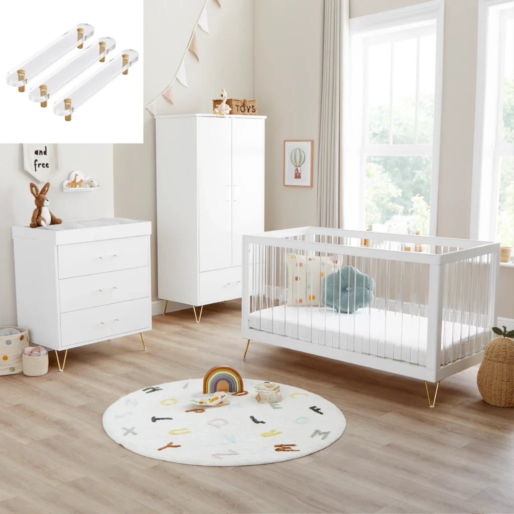 Nursery room with white crib, dresser, and round rug on wooden floor.