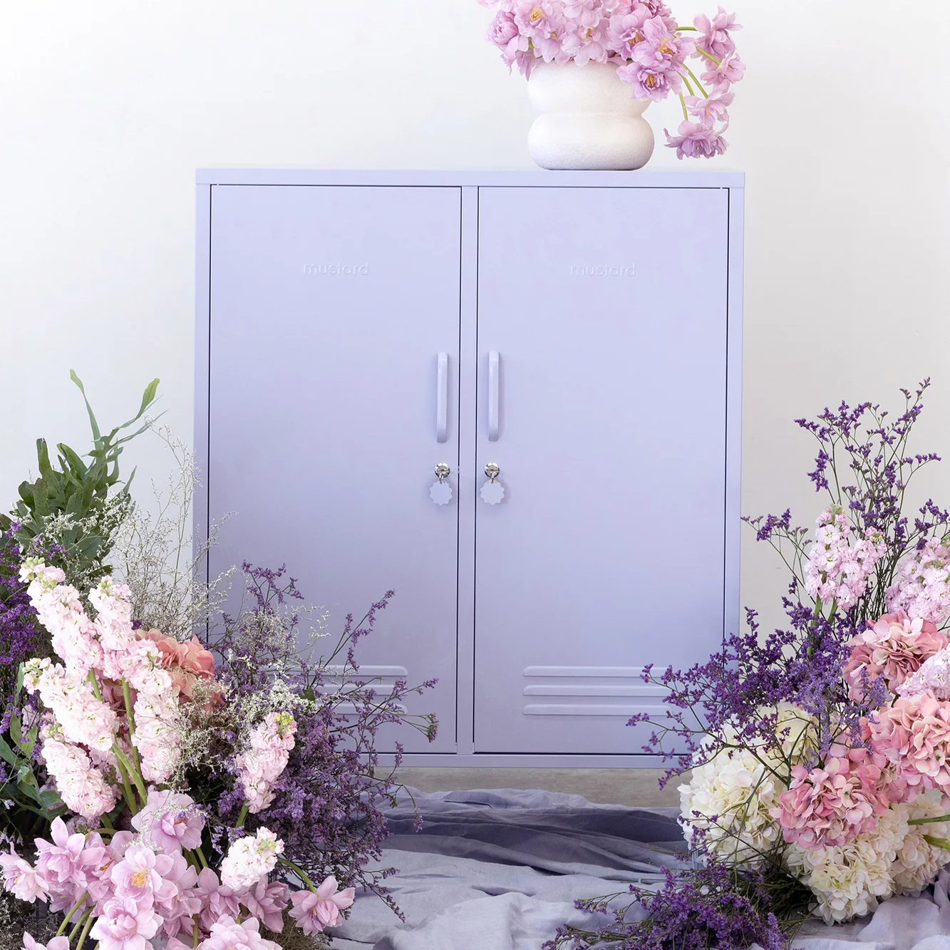 Purple locker with pink flowers on a white background