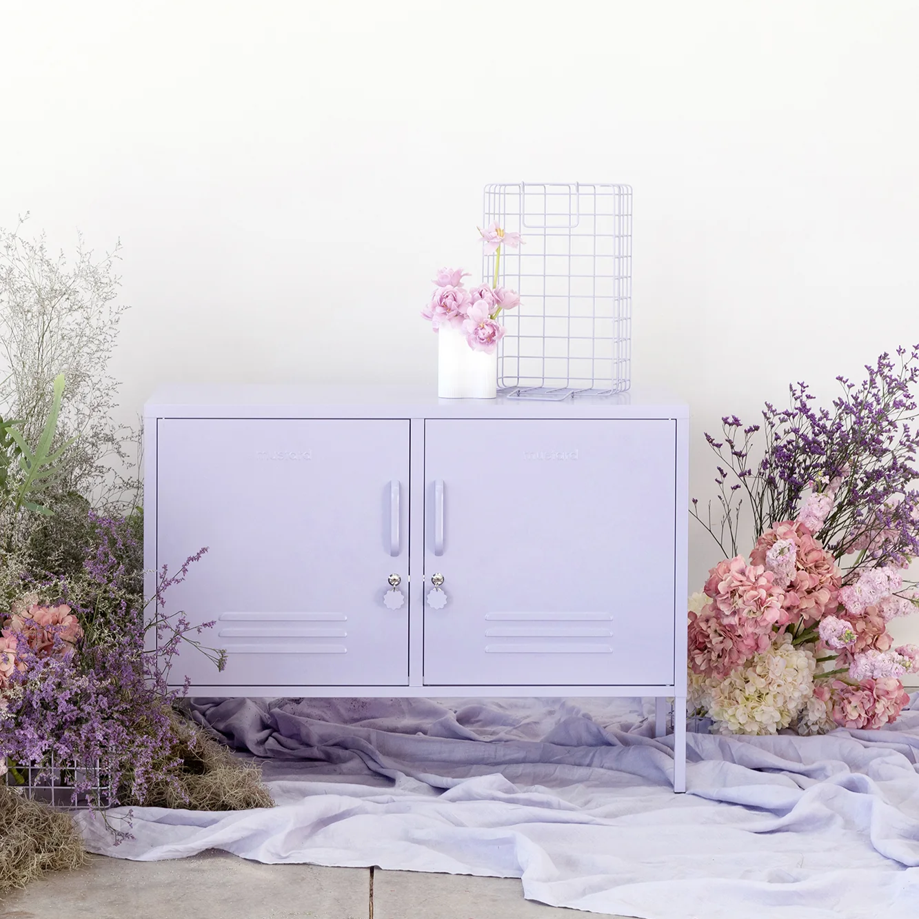 Light purple cabinet with floral decorations on a white background