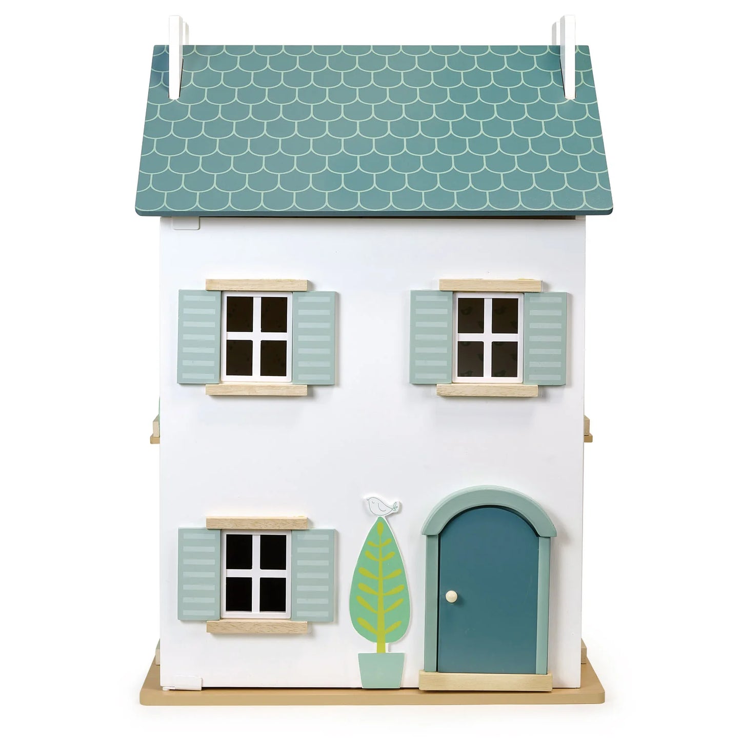 Small model house with a green roof and door on a white background