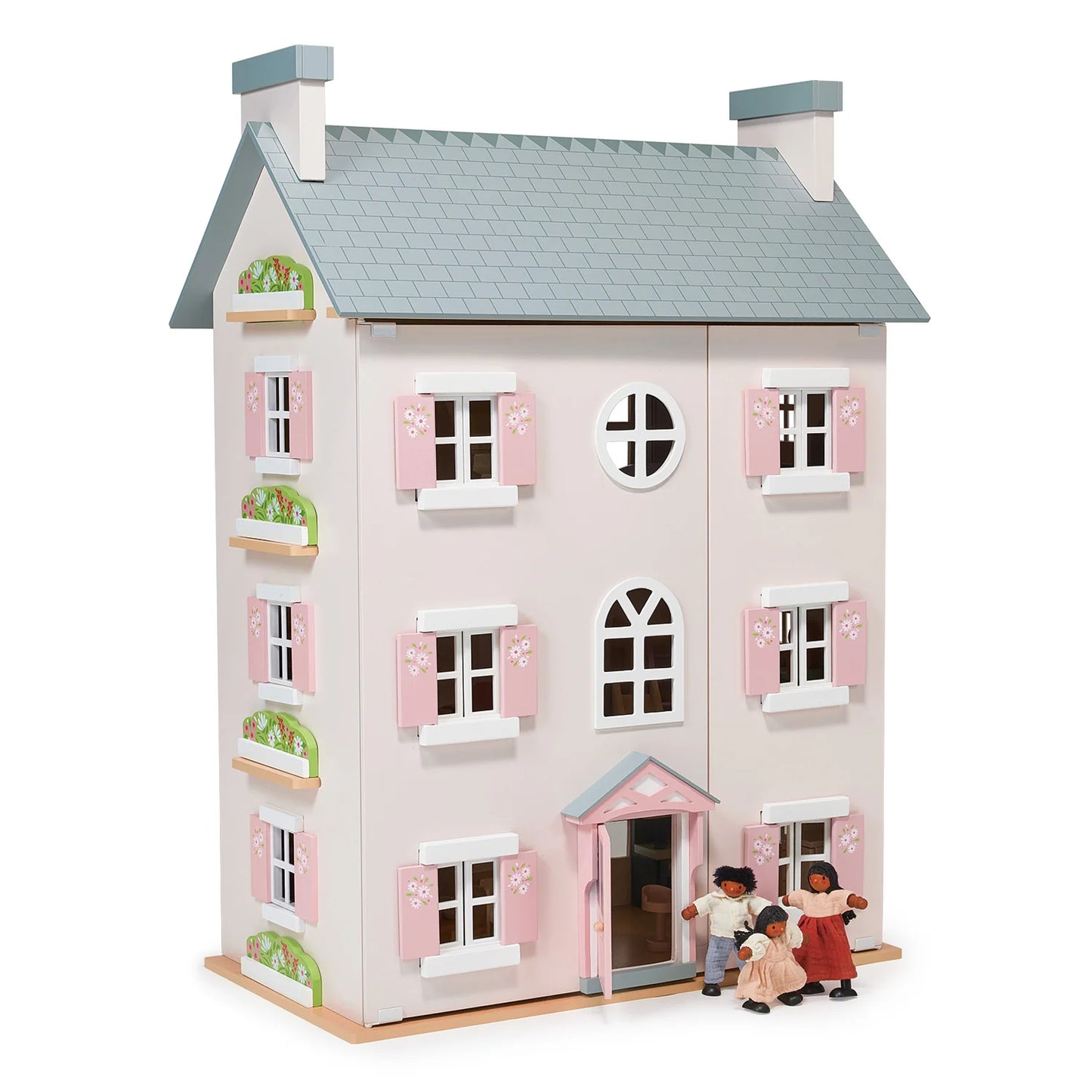 Pink dollhouse with toy family on a white background