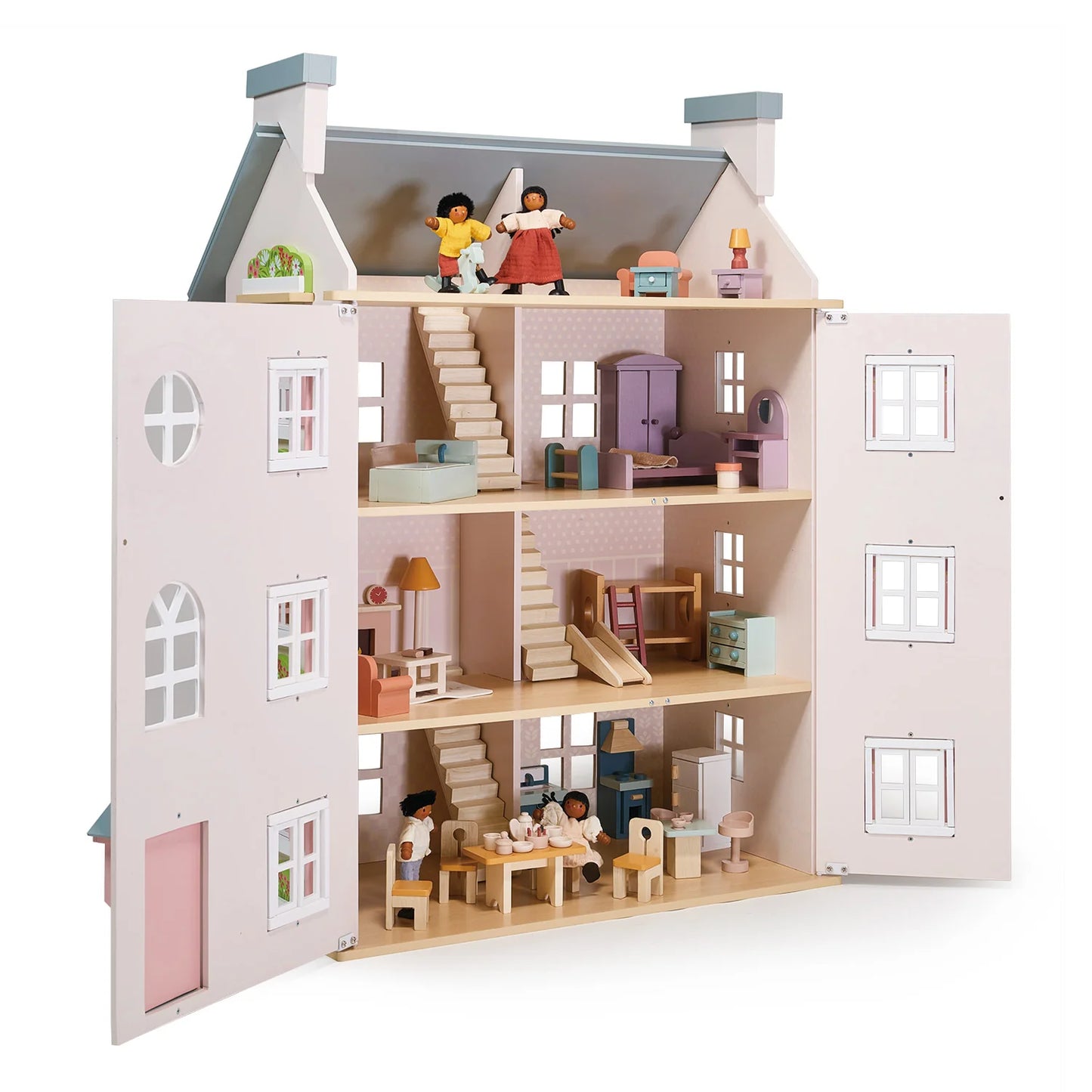 Wooden dollhouse with multiple levels, furniture, and dolls on a white background