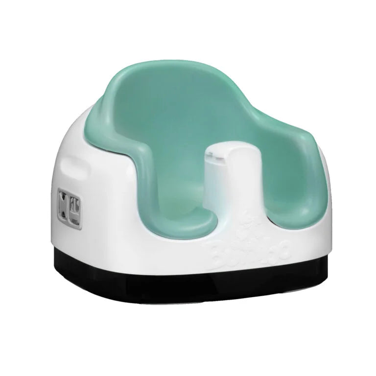 Children's potty seat with green seat and white base on a white background