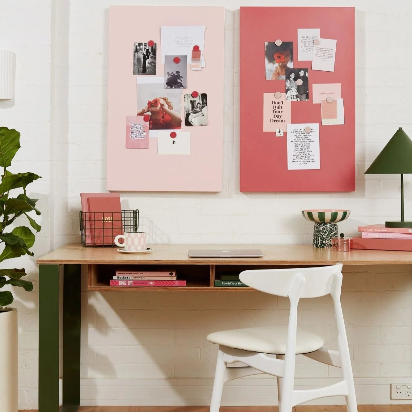 Home office with a desk, chair, and decorative elements on the wall.