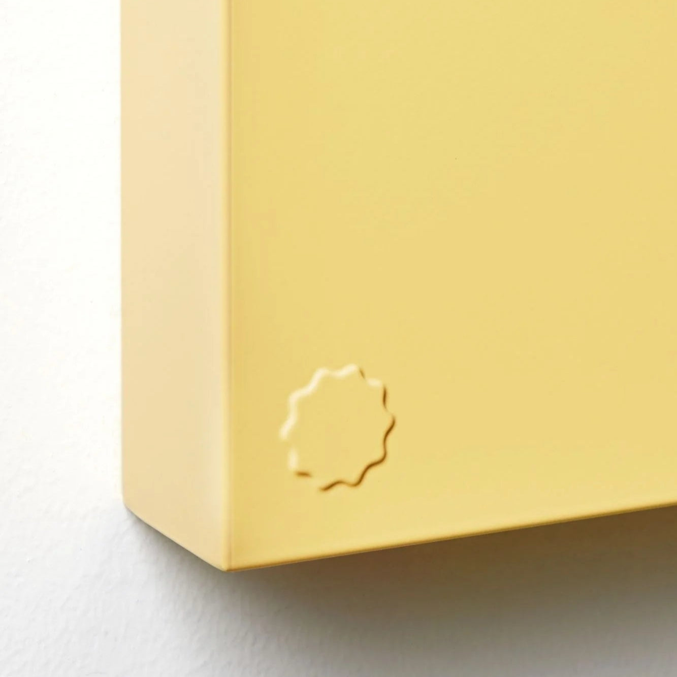 Yellow book with a logo on a light gray background