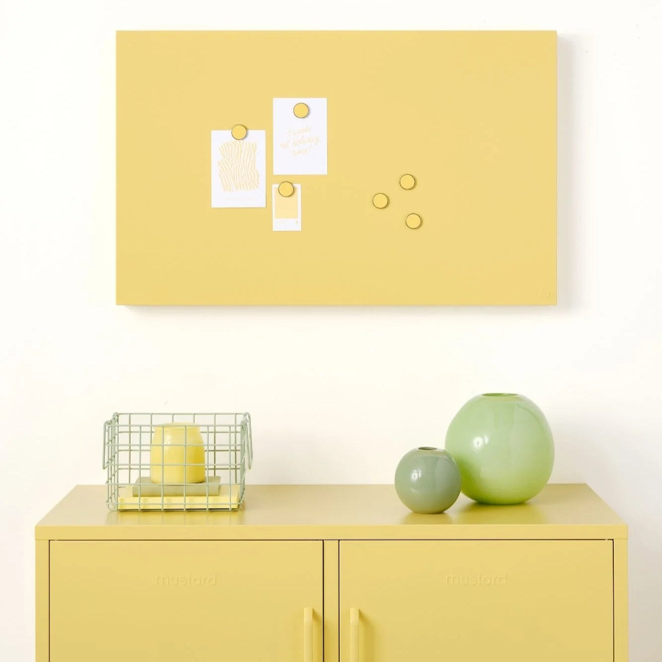 Yellow cabinet with decorative items against a white wall