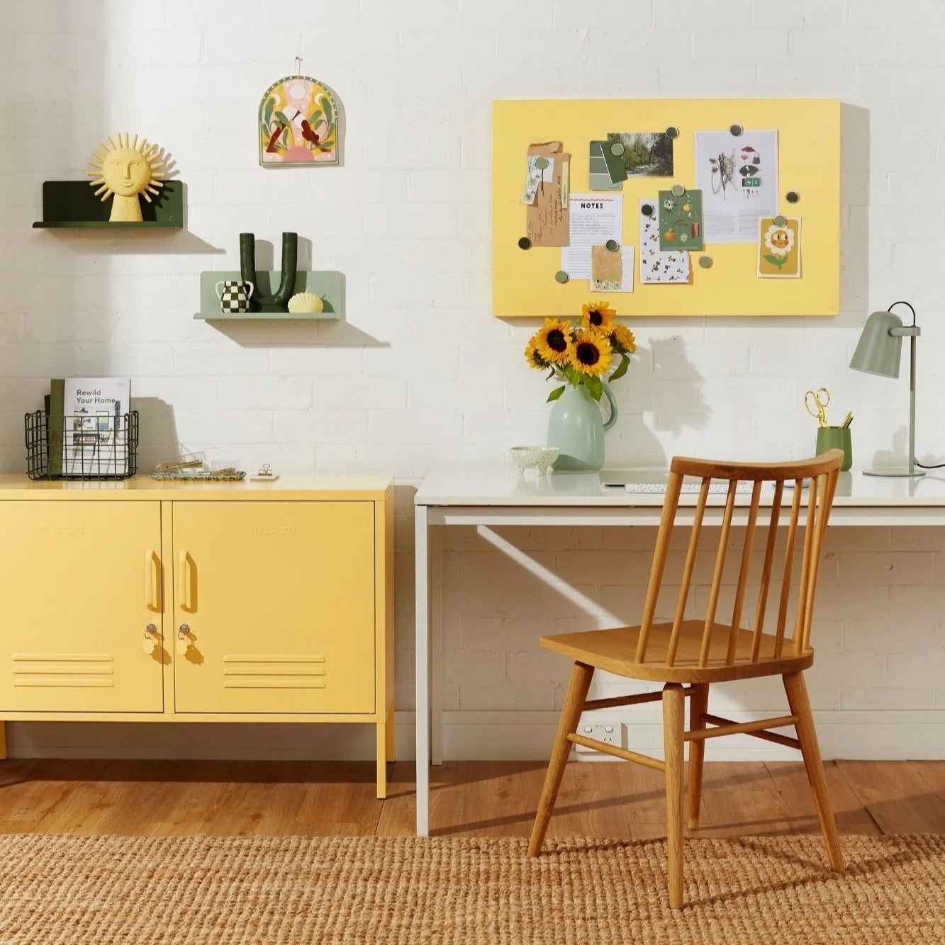 Yellow cabinet, table, and chair in a room with a white wall and wooden floor.