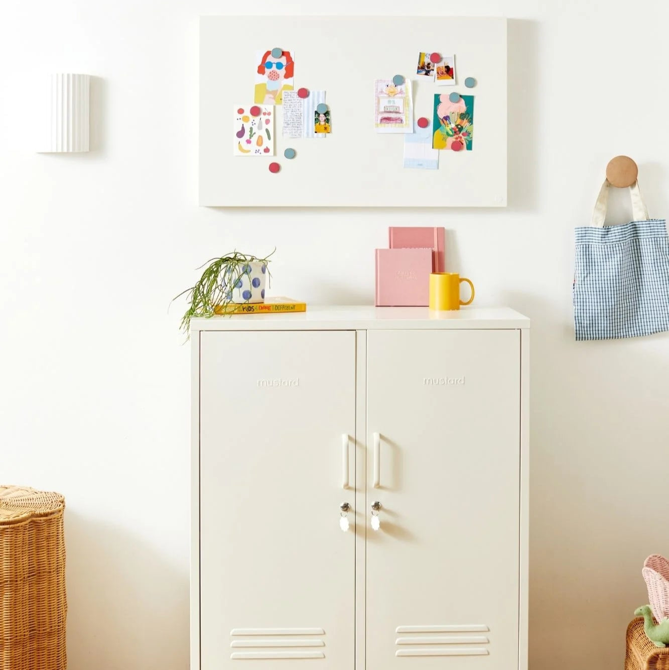 White cabinet with decorative items on a wooden floor in a room.