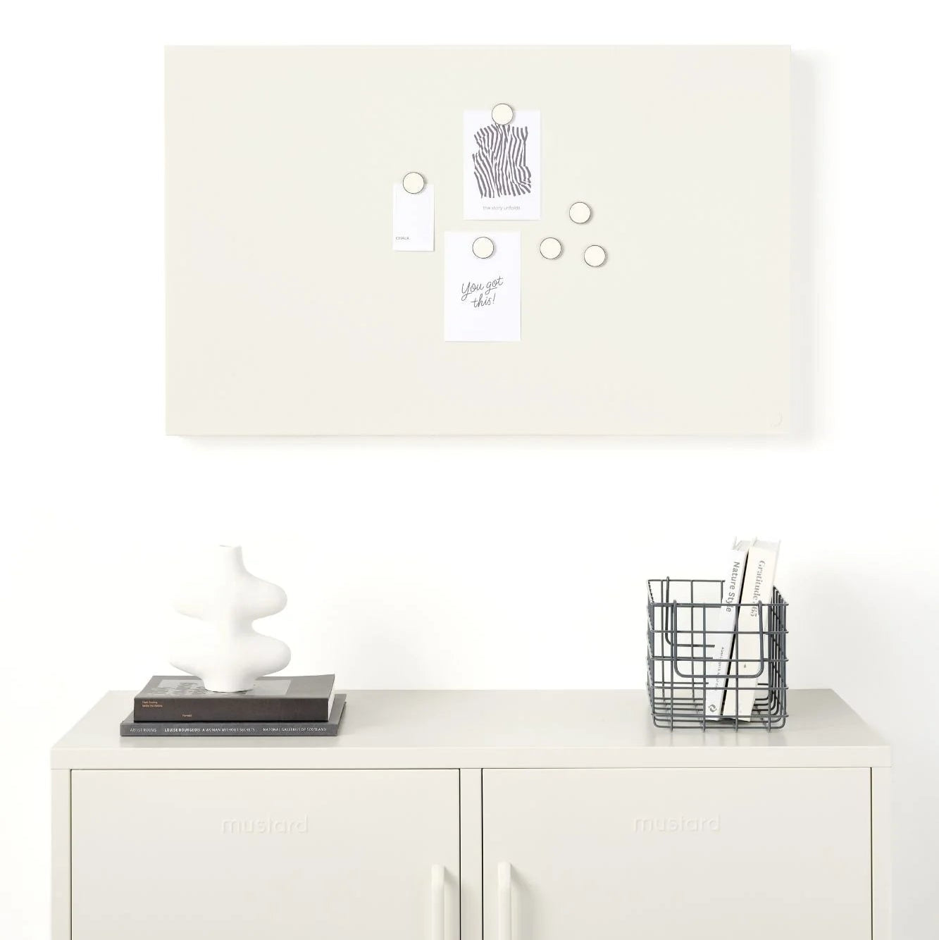 White locker-style cabinet with a lamp, decorative items, and a basket on top against a white wall.