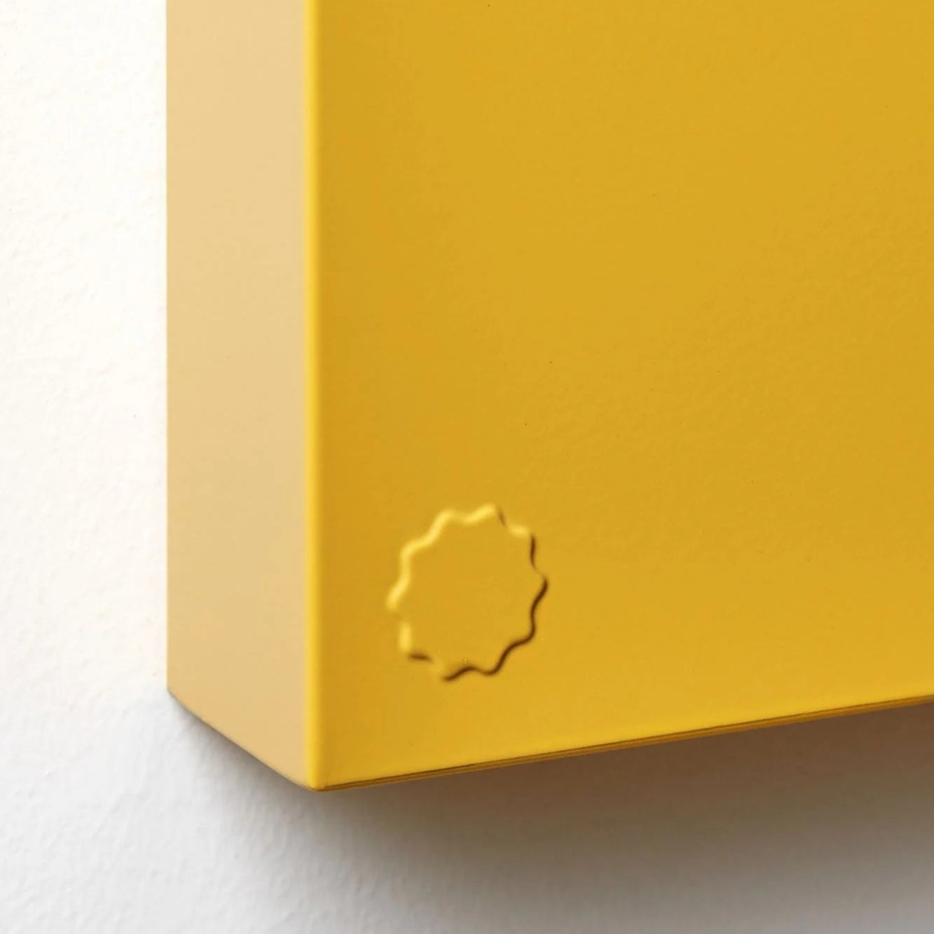 Yellow box with a circular logo on a white background