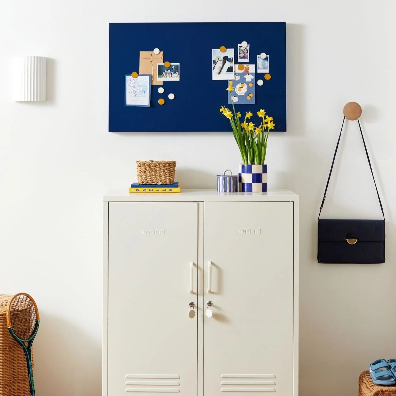 White cabinet with decorative items against a white wall