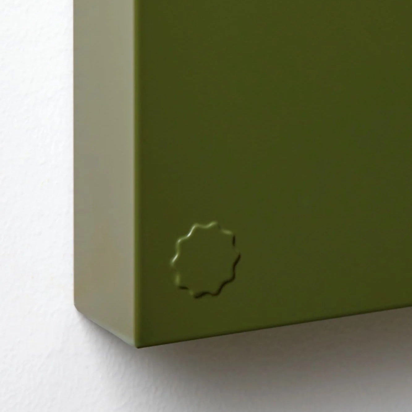 Close-up of a green box with a logo on a white background