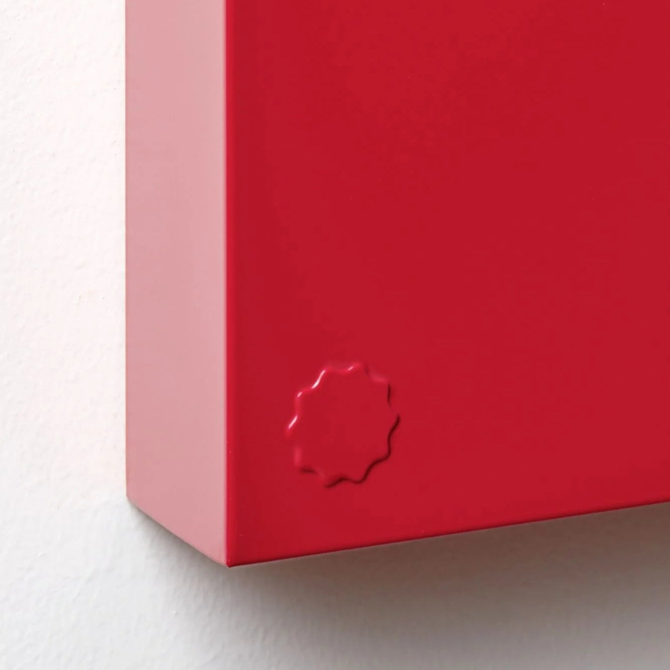 Close-up of a red box with a brand logo on a white background