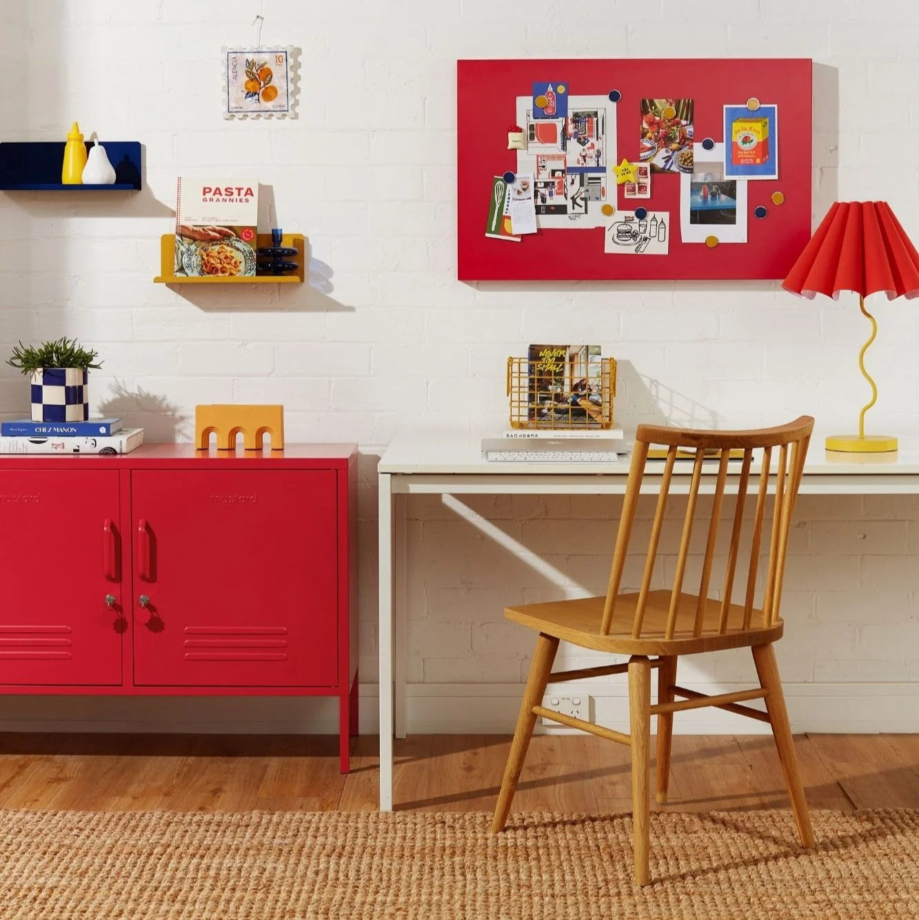 Home office with red cabinet, white desk, and wooden chair.