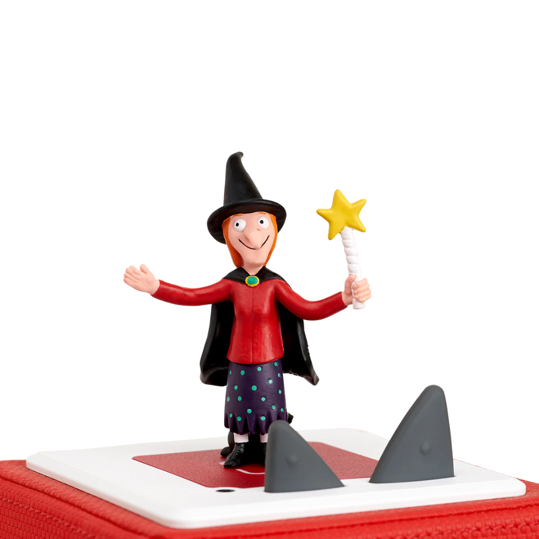 Toy figure of a witch with a broom on a white background