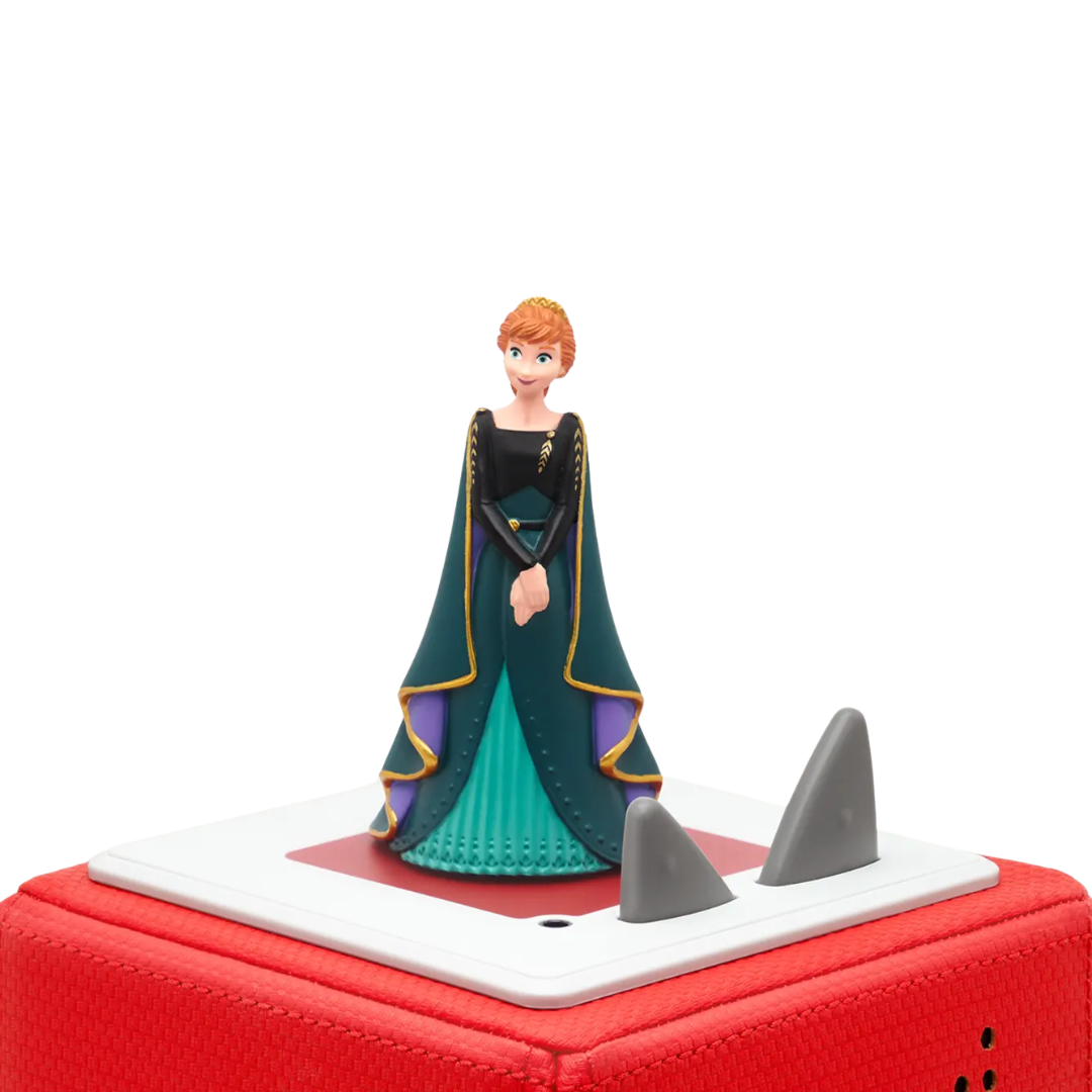 Toy figure of a character in a green dress on a red and white base with shark fins.