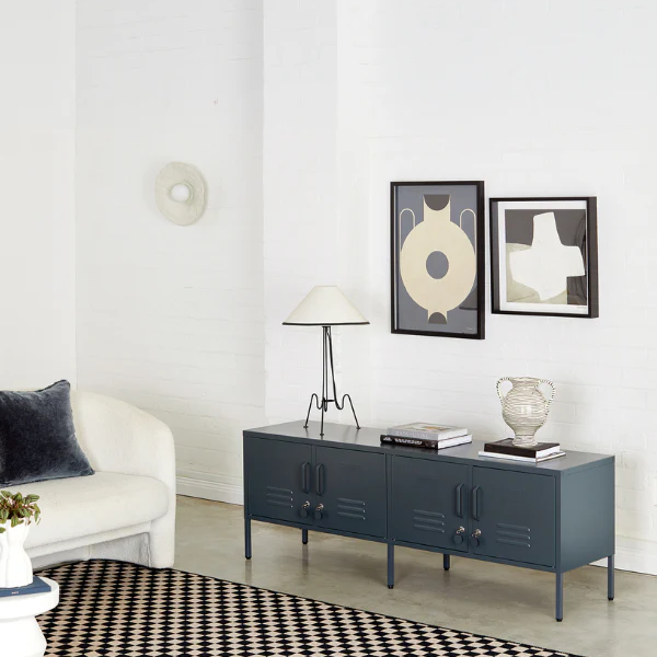 Modern living room with a blue cabinet, white sofa, and decorative items.