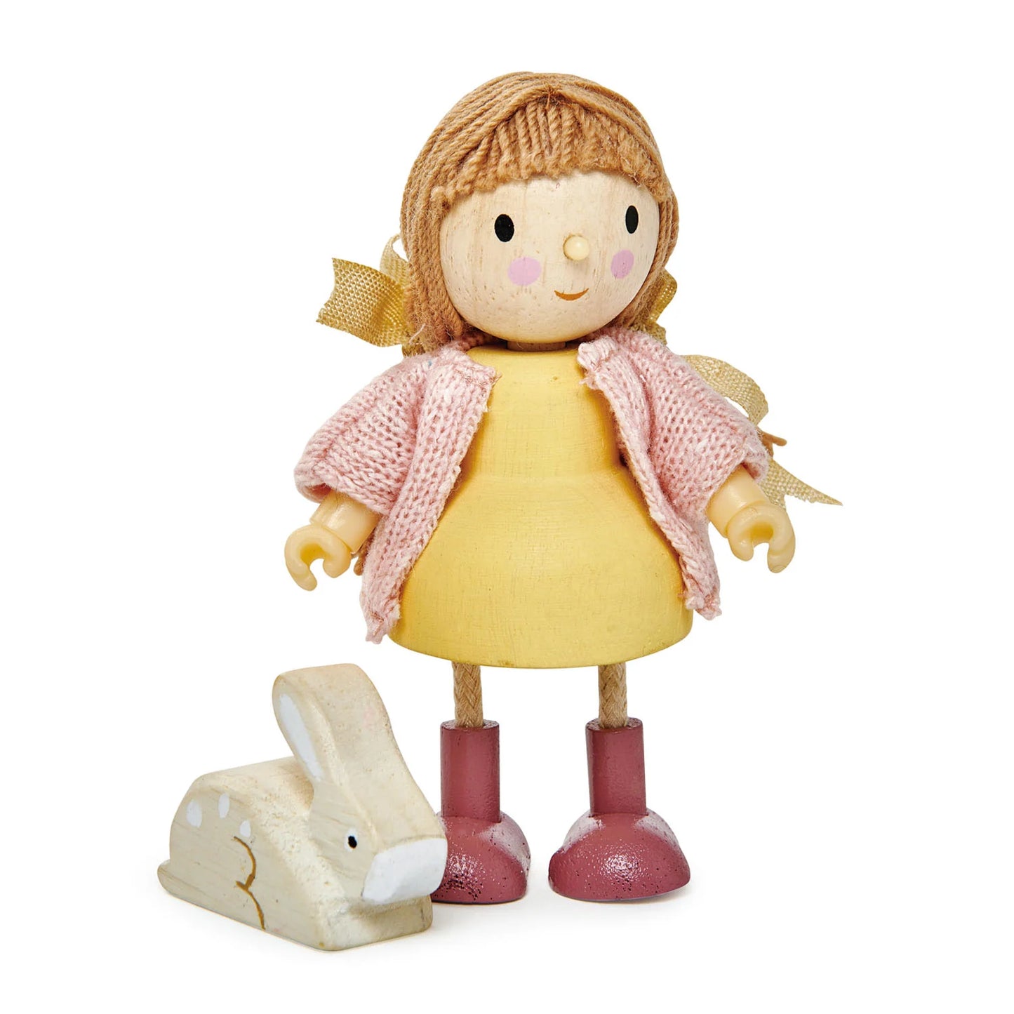 Toy doll with a yellow dress and pink scarf, standing next to a wooden rabbit toy on a white background.